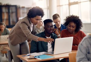 African American professor working with college students